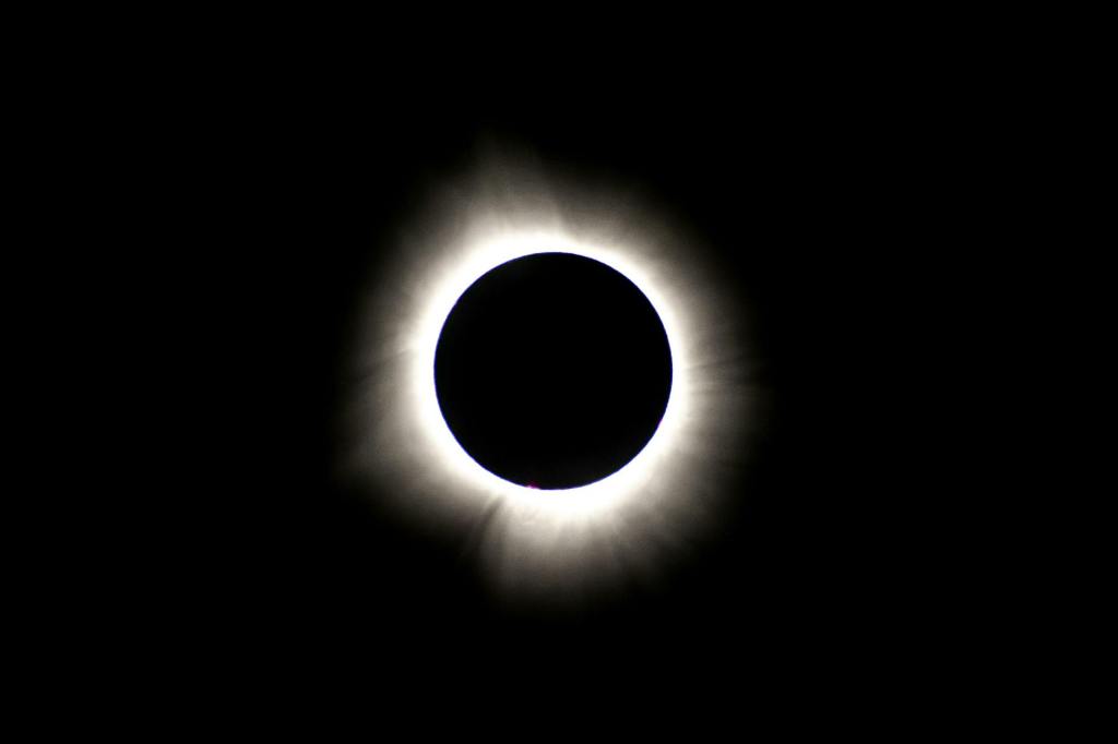 Image of a solar eclipse against a blackened sky
